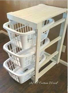 three laundry baskets stacked on top of each other in front of a wooden floor and wall