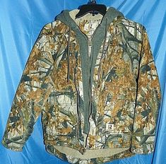 VERY NICE, VERY CLEAN REAL WORK WEAR MOSSY OAK CAMO HOODED JACKET SMALL REGULAR (35-38)!! MEASUREMENTS: SHOULDER TO CUFF 26-27" ARMPIT TO ARMPIT 22.5" BACK OF NECK TO BOTTOM HEM 27-28" 4 FRONT POCKETS 2 INSIDE POCKETS, 1 INSIDE ZIPPER POCKET SHELL 100% COTTON HOOD COTTON BLEND LINING FILLER 100% POLYESTER VERY NICE JACKET FOR HUNTING, FISHING, OUTDOOR SPORTS. HAS FRONT ZIP AND SNAP CLOSURE WITH DRAWSTRING HOOD. THANK YOU FOR LOOKING!! I SELL GOOD QUALITY ITEMS SO PLEASE CHECK OUT MY OTHER LISTIN Camo Hunting Jacket, Hunting Jacket, Mossy Oak Camo, Spring Jacket, Hunting Jackets, Realtree Camo, Vests Mens, Camo Jacket, Mossy Oak