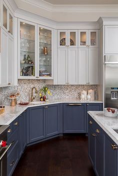 a kitchen with blue cabinets and white counter tops