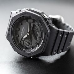 Ρολόι Casio G-Shock GAE-2100GC-7AER που συνδυάζει μαύρο λουράκι από καουτσούκ και μαύρο καντράν με πλαίσιο σε οκτάγωνο σχημα. Με στεγανότητα 20ATM-200Μ που το καθιστά κατάλληλο για καταδύσεις, τζαμάκι από ορυκτό ειδικής σκλήρυνσης, μηχανισμό μπαταρίας και στεφάνη σε διάμετρο 45,4mm. Η ένδειξη του ρολογιού είναι τόσο ψηφιακή όσο και αναλογική, ενώ διαθέτει λειτουργίες χρονογράφου, χρονόμετρου και ένδειξης ημέρας/ημερομηνίας και φωτιζόμενη οθόνη με τεχνολογία Backlight. *Η αγορά του Casio G-Shock Watch Image, Casio G Shock, G Shock, Casio Watch, Black Rubber, Wood Watch, Classic Black, Gift Shop, Google Search