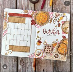 an open planner book sitting on top of a wooden table