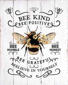 a bee is sitting on top of a wooden sign with the words be kind of positive