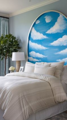 a bedroom with a large painting on the wall above the bed and pillows in front of it