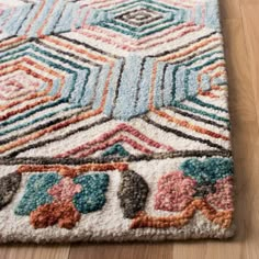 a multicolored area rug with an abstract design on the top and bottom corner