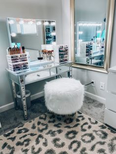 a vanity with a stool and mirror in a room that has a rug on the floor