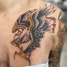 an eagle tattoo on the back of a man's upper half - arm and chest