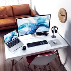 two computers are sitting on a white desk