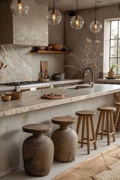 an image of a kitchen setting with vases on the counter and stools in front