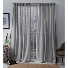 the curtains in this living room are made from light gray linens and have an elegant drape