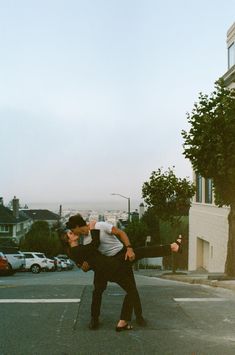 two people standing in the middle of an empty street