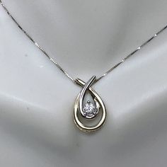 One 14k Two Tone Color Diamond Pendant Necklace. Double Teardrop Shaped Pendant Prong Set One Round Brilliant Diamond, Approx. 3.8mm, Weight Approx. 0.23ct, I Color And Si2-I Clarity. The Pendant Is 18.8 X 11.5 X 5mm, It Suspends Along An 18" Box Link Chain, Spring Ring Clasp. The Necklace Is 18" Long, Wight 2" Extension. Weight 3.5gm, Hallmark 14k Diamond Box, Diamond Pendant Necklace, Brilliant Diamond, Link Necklace, Spring Rings, Diamond Pendant, Link Chain, Round Brilliant, Prong Setting