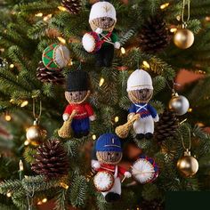 the ornaments are hanging on the tree for christmas decorating ornament set, which includes three nutcrackers and two snowmen