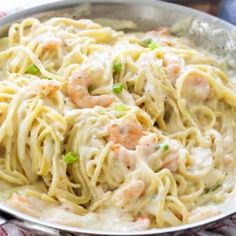 pasta with shrimp and cream sauce in a pan