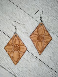 Earrings are lightweight and hand tooled from scratch. Finished product may vary slightly from the picture due to its handmade nature. Earrings are finished with silver earring hooks for easy wearing. Brown Dangle Flower Earrings For Pierced Ears, Brown Flower Earrings With Ear Wire, Brown Flower Drop Earrings, Brown Flower Earrings, Beige Leather Jewelry, Hand Tooled Brown Earrings For Everyday Wear, Brown Hand Tooled Everyday Earrings, Everyday Brown Faux Leather Jewelry, Tooled Leather Earrings