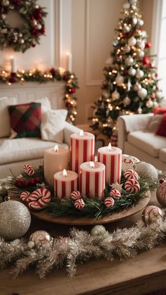 candles are arranged on a tray in front of christmas decorations