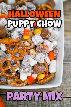 halloween puppy chow party mix in a white square bowl with candy and pretzels