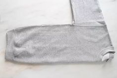 a pair of grey sweatpants sitting on top of a white counter