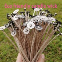 a person holding up some kind of candle wick in their hand with the words eco friendly candle wick written on it