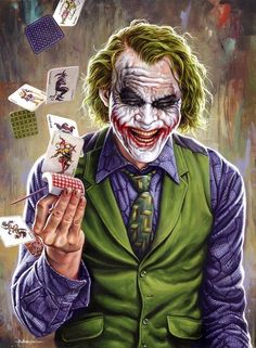 the joker is playing cards with his hands and holding it in one hand as if he was