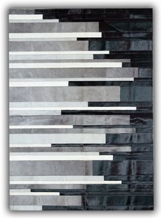 an area rug with black, white and grey stripes on the floor in front of it