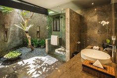 a bathroom with a sink, shower and large mirror in it's center area