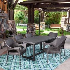 an outdoor dining table and chairs on a rug