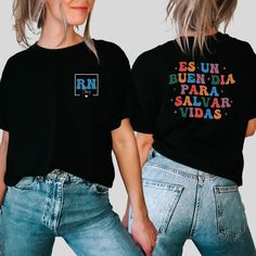 two women wearing black tshirts with colorful letters on them