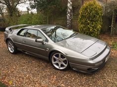 a silver sports car parked in front of a house