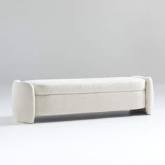 a white bench sitting on top of a white floor