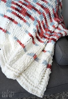 a blanket that is sitting on top of a couch