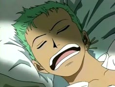 a man laying in bed with his eyes closed and green hair on top of him