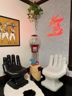 a room with two chairs, a snow globe and a neon sign