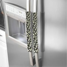 the door handle is attached to the refrigerator's handles, which are decorated with black and white leopard print