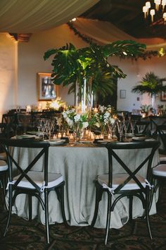 the table is set with candles and greenery for an elegant dinner or reception party