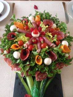 an arrangement of vegetables and meats on a table