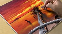 someone is painting a sunset scene with giraffes