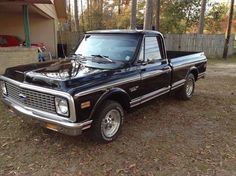 a black truck parked in front of a house