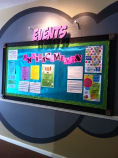 a bulletin board is hanging on the wall in front of a sign that says events