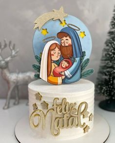 a christmas cake with a nativity scene on top and gold lettering that reads, feli's night