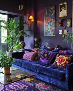 a living room filled with purple couches and lots of pillows