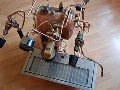 an image of a machine that is on top of a wooden floor with some wires attached to it