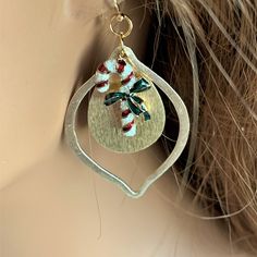 The holidays will be here soon, and you will be ready for the parties wearing these elegant gold candy cane earrings!  Red, white and green candy cane charms hang inside teardrop shaped brushed gold dangles.  The 2.5-inch holiday earrings are pretty and lightweight.  The pretty earrings dangle from gold filled ear wires. These earrings are handmade by me, Sharon, of Blonde Peach Jewelry. They will arrive in an attractive organza bag that is great for storage and gift giving. Feel free to contact Handmade Holiday Jewelry, Candy Cane Earrings, Pretty Earrings Dangle, Colorful Choker, Beachy Earrings, Green Candy Canes, Peach Jewelry, Gold Candy, Green Charms