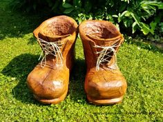 a pair of wooden boots sitting in the grass