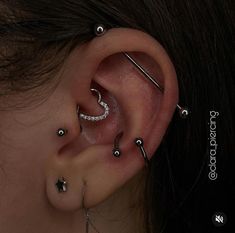 a woman with piercings on her left ear