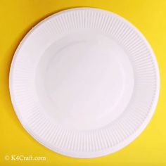 a white plate sitting on top of a yellow table