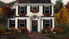 a white house with green shutters and fall foliage