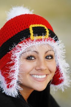 a smiling woman wearing a santa hat