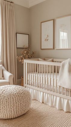 a baby's room with a white crib and two pictures on the wall