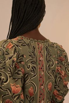 Embrace the essence of tropical elegance with the Arabesque Floral Green Blouse. A delight for the senses, this piece features a vibrant display of florals in warm peach against a serene green backdrop, enveloped in an exquisite arabesque pattern. The high neckline is framed by gently puffed sleeves, creating a silhouette that whispers of timeless romance while the delicate trims add a touch of understated charm. This blouse is a poetic ode to the beauty of the natural world. Rio Brazil, Colorful Blouses, Arabesque Pattern, Green Backdrops, Daytime Dresses, Printed Dresses, Denim Romper, Dress Gift, European Summer