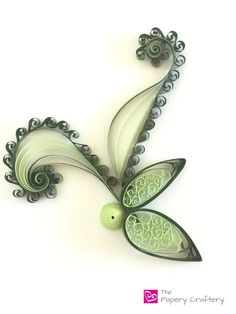 a green and white flower with swirls on it's petals is shown in the shape of a butterfly